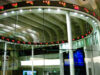 MEXC Appoints Robert MacDonald Chief Compliance Officer as Exchange Expands Into Tokenized Markets Trading screens on the market floor of a stock exchange