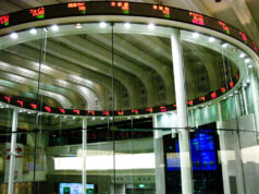 MEXC Appoints Robert MacDonald Chief Compliance Officer as Exchange Expands Into Tokenized Markets Trading screens on the market floor of a stock exchange