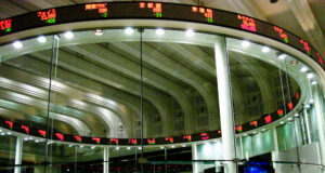 MEXC Appoints Robert MacDonald Chief Compliance Officer as Exchange Expands Into Tokenized Markets Trading screens on the market floor of a stock exchange