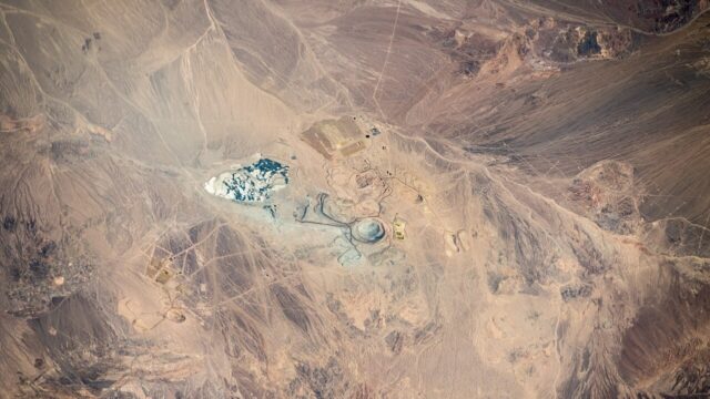 Aerial view of open-pit mining operations in a desert landscape
