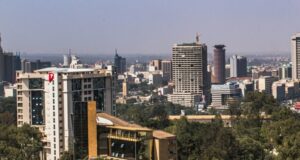 Grit Real Estate accepts a conditional binding offer for its development platform and progresses a proposed portfolio disposal Daylight view of an African city commercial district with office towers and tree cover, a generic stock illustration that does not depict any property owned or managed by the companies named in this report.