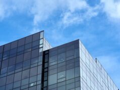 Xbox Chief Operating Officer Helen Chiang Departs Microsoft After Three Months in the Role A glass-fronted corporate technology office building under a clear daytime sky