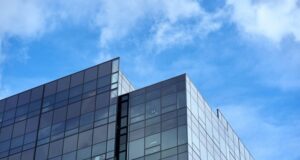 Xbox Chief Operating Officer Helen Chiang Departs Microsoft After Three Months in the Role A glass-fronted corporate technology office building under a clear daytime sky