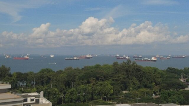 Cargo and support ships at anchor off Singapore on a clear day
