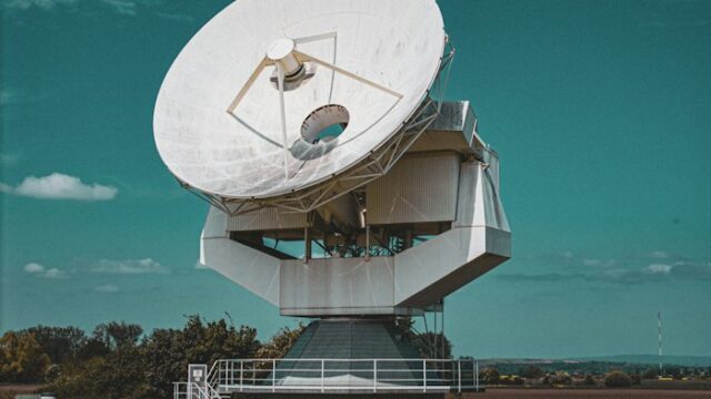 A large satellite dish antenna against a blue sky
