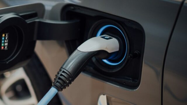 An electric vehicle charging cable plugged into a car