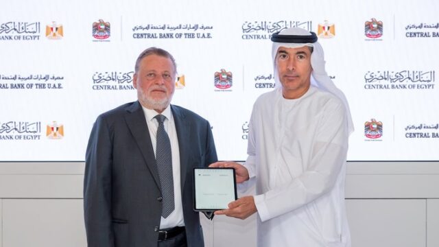 Khaled Balama of the Central Bank of the UAE and Hassan Abdalla of the Central Bank of Egypt sign the renewed currency swap